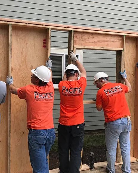 Three construction workers in orange