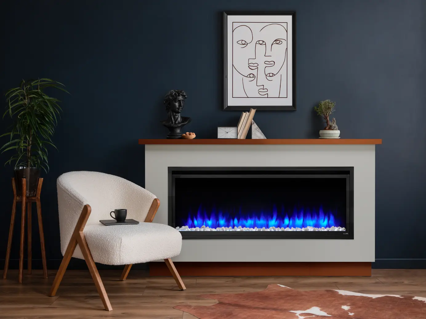 A modern living room with a white chair and wooden legs, a small plant, and a fireplace with blue flames. Above the fireplace is minimalist art and small sculptures on the mantle.