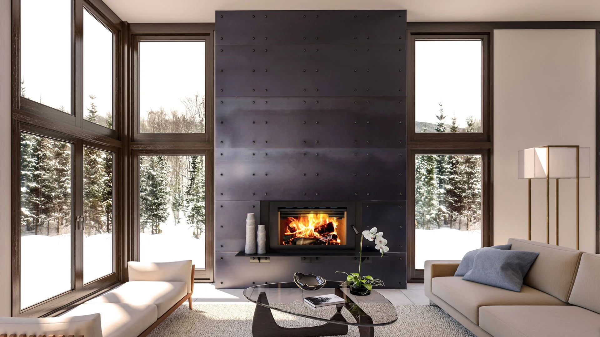 Modern living room with large windows showcasing a snowy forest view, featuring a black metal fireplace with a fire burning, along with a beige sofa, beige bench, and glass coffee table.