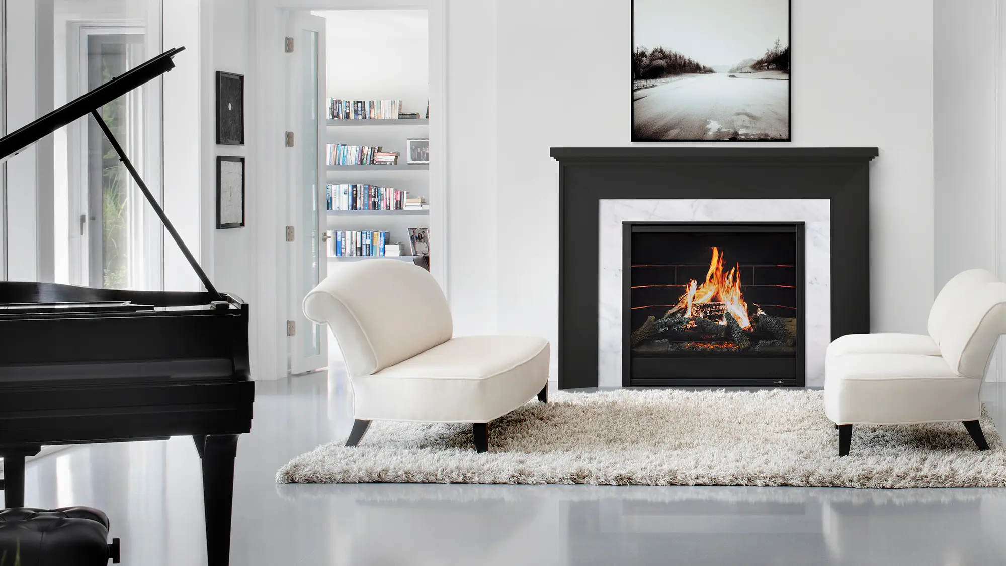 A modern living room with a black grand piano, two white armchairs, a fireplace with a burning fire, a rug, and a bookshelf in the background through an open door.