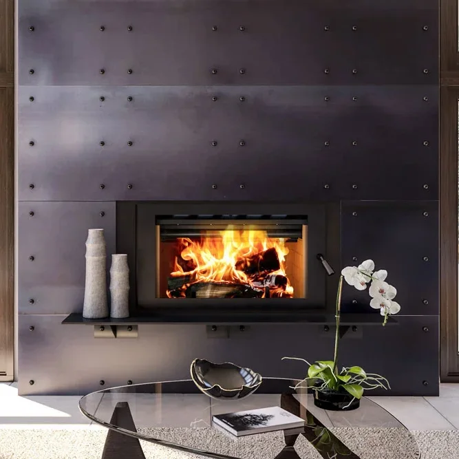 Modern living room with large windows showcasing a snowy forest view, featuring a black metal fireplace with a fire burning, along with a beige sofa, beige bench, and glass coffee table.