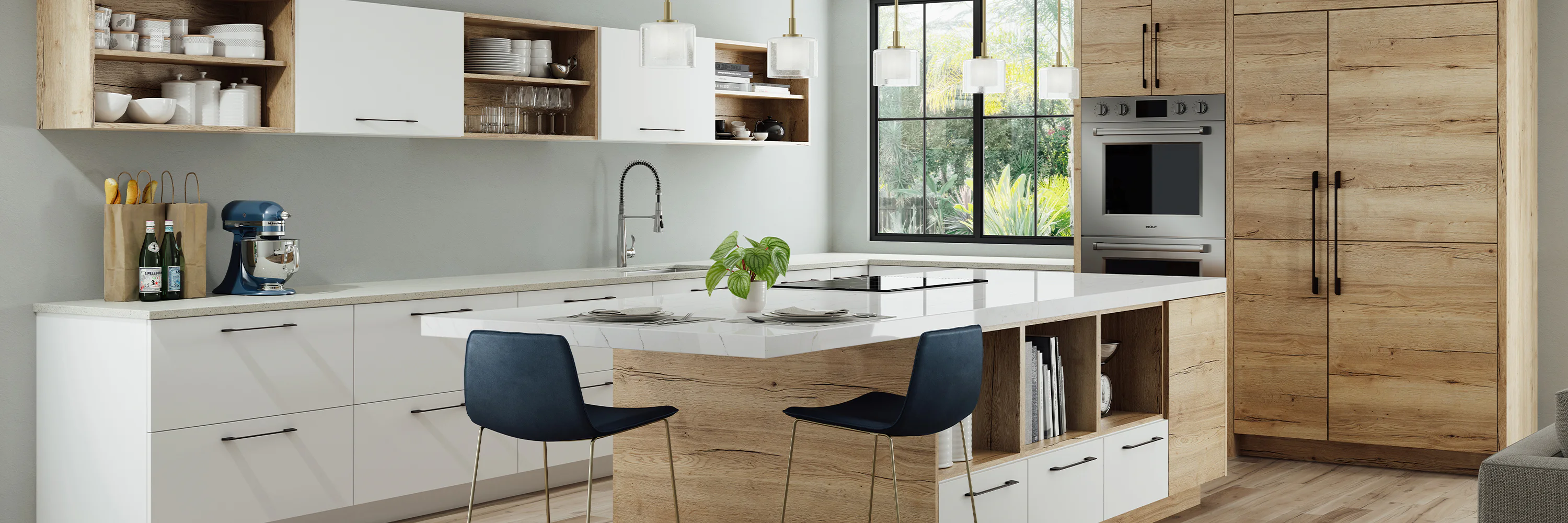 Modern kitchen featuring a central island with a white countertop and two black chairs, wooden and white cabinets, a blue mixer, brown grocery bags, and large windows with a garden view.