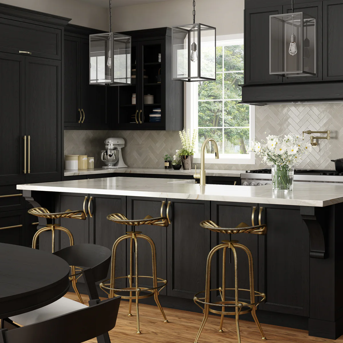 Modern kitchen with dark cabinets, brass fixtures, and white countertops. Features include pendant lights, a mixer, flowers on the island, and a window with greenery outside.