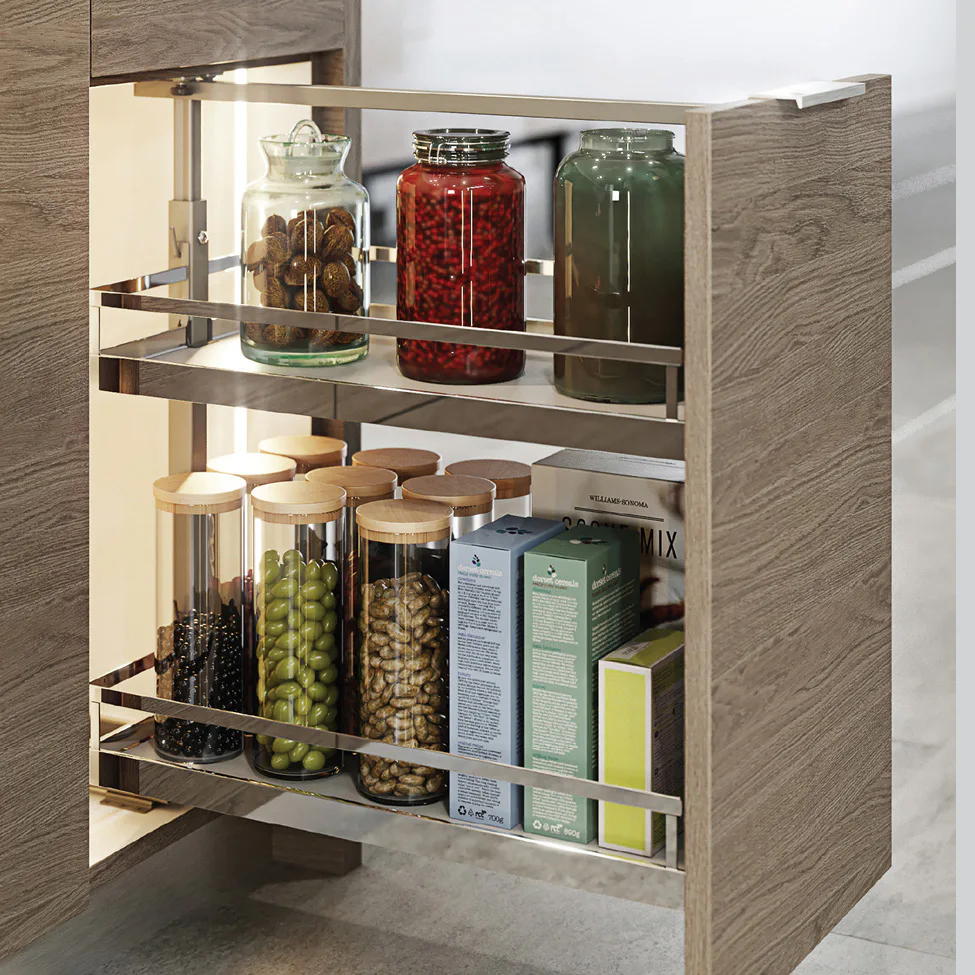 Pull-out kitchen cabinet with two metal shelves holding glass jars of nuts, beans and boxed pantry items.
