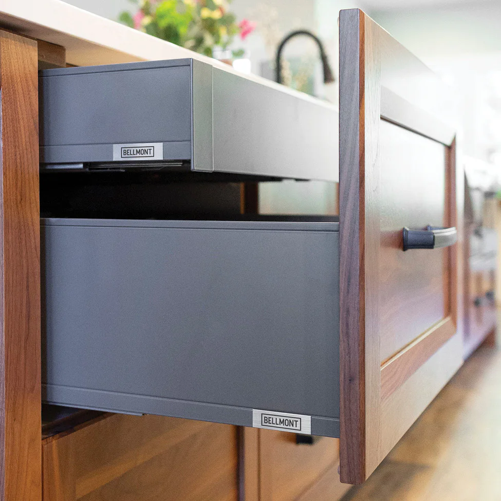 Open kitchen drawer with wooden front and gray metal interior labeled 'BELLMONT'