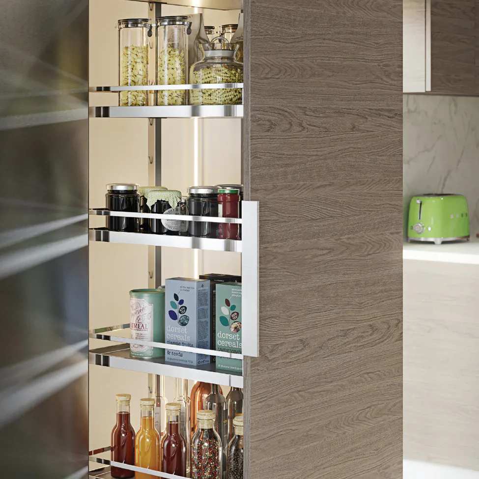 Open pull-out kitchen pantry with glass jars, cereal boxes, condiments and bottles on chrome shelves