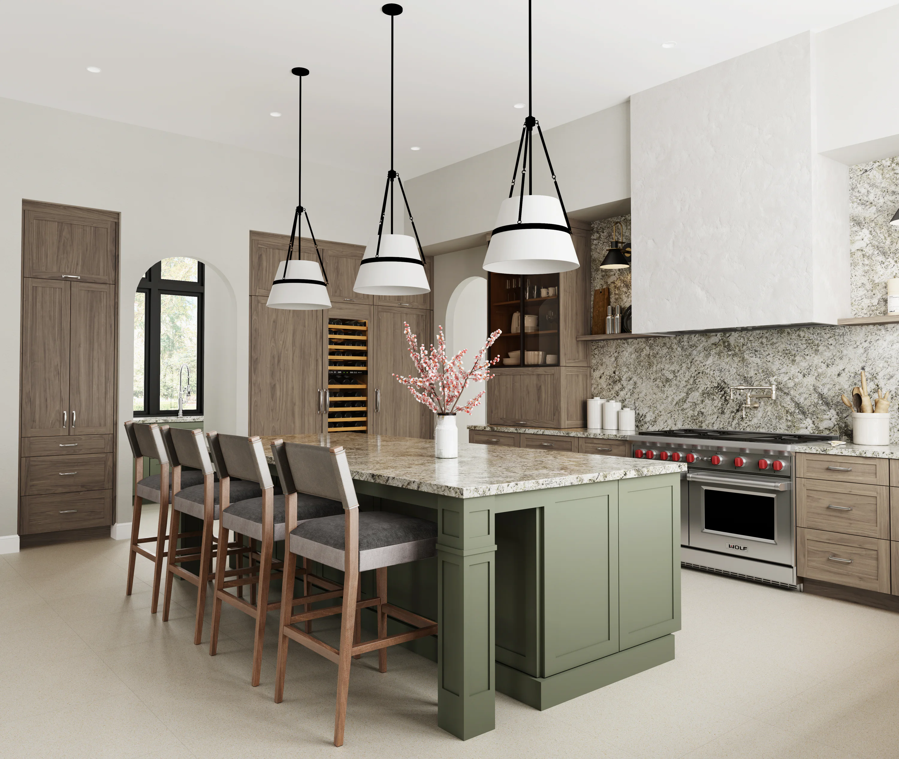 Modern kitchen with a green island, granite countertop, four bar stools, pendant lights, wooden cabinets, and stainless steel appliances. A vase with pink flowers on the island.