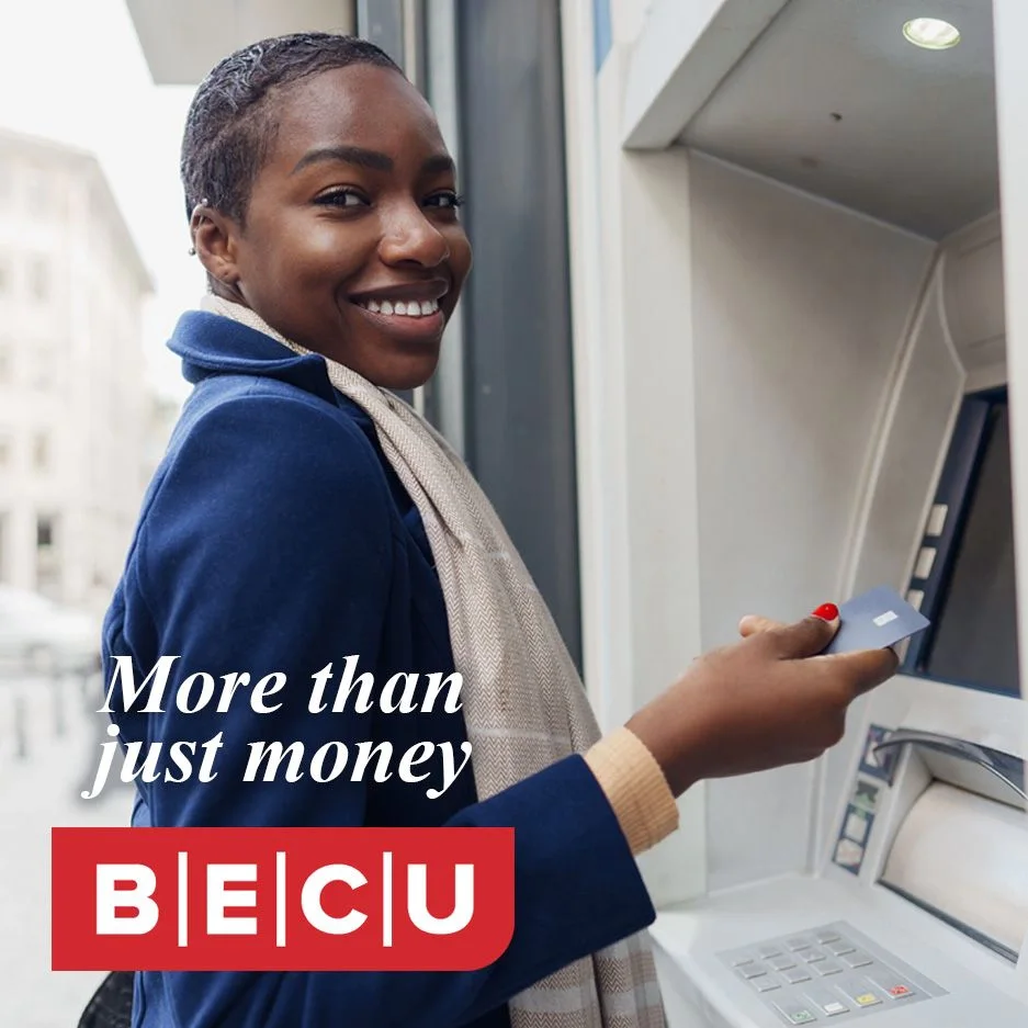A person smiles while using an ATM. Text reads 