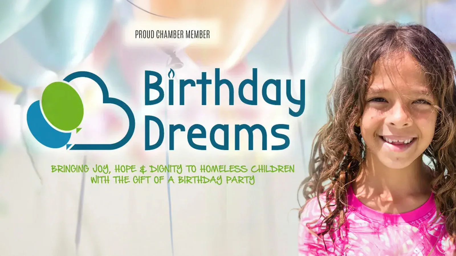 A smiling child in a pink shirt stands next to the 