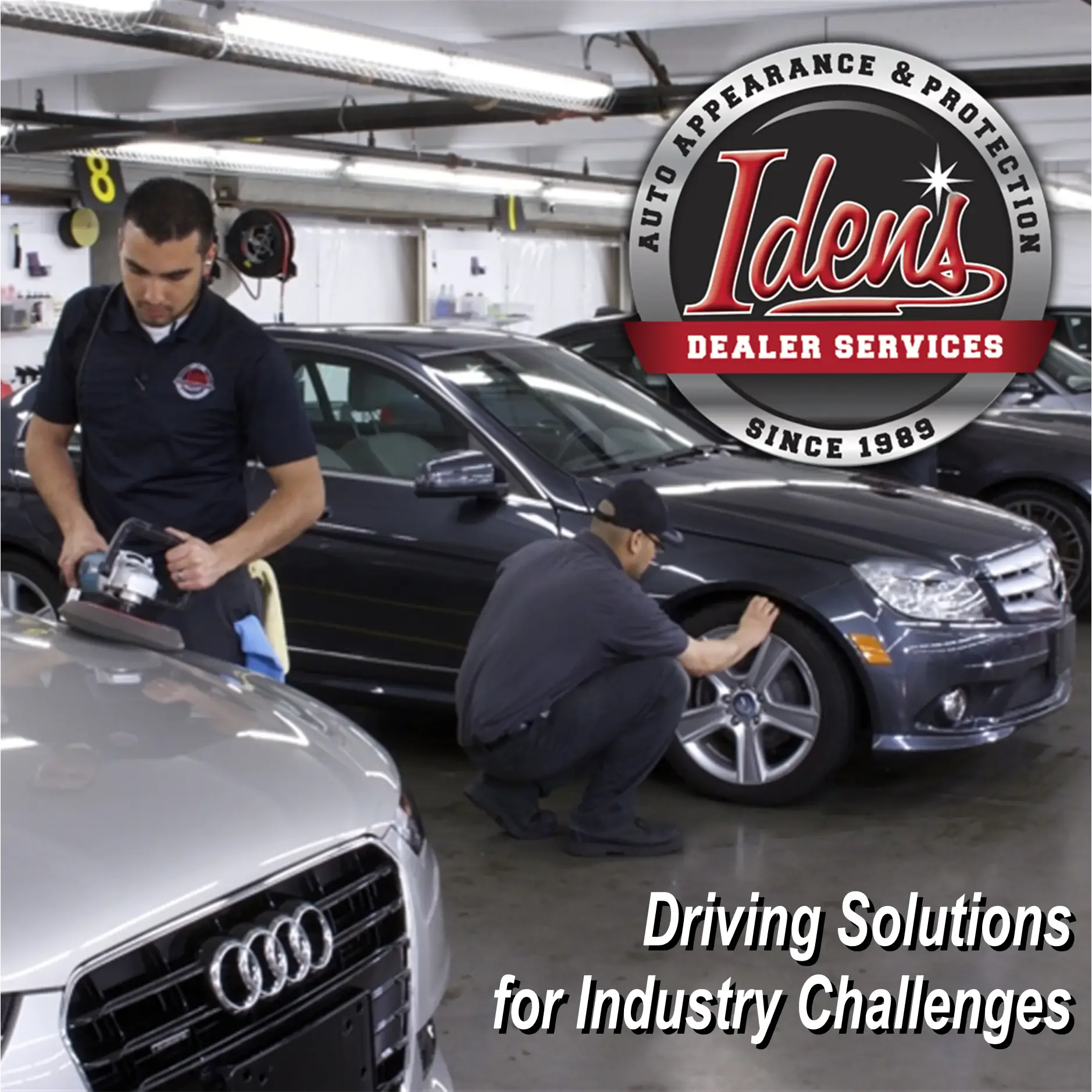 Auto detailing experts working on luxury cars in a garage. 