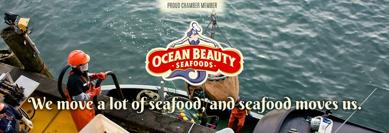 Fisherman in an orange suit works on a boat docked at a pier. Ocean Beauty Seafoods logo and text overlay: 