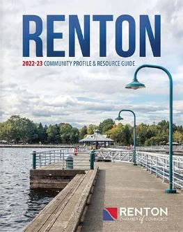 Cover of the Renton 2022-23 Community Profile & Resource Guide, featuring a pier with vintage street lamps by a lake, surrounded by trees, with a cloudy sky above.