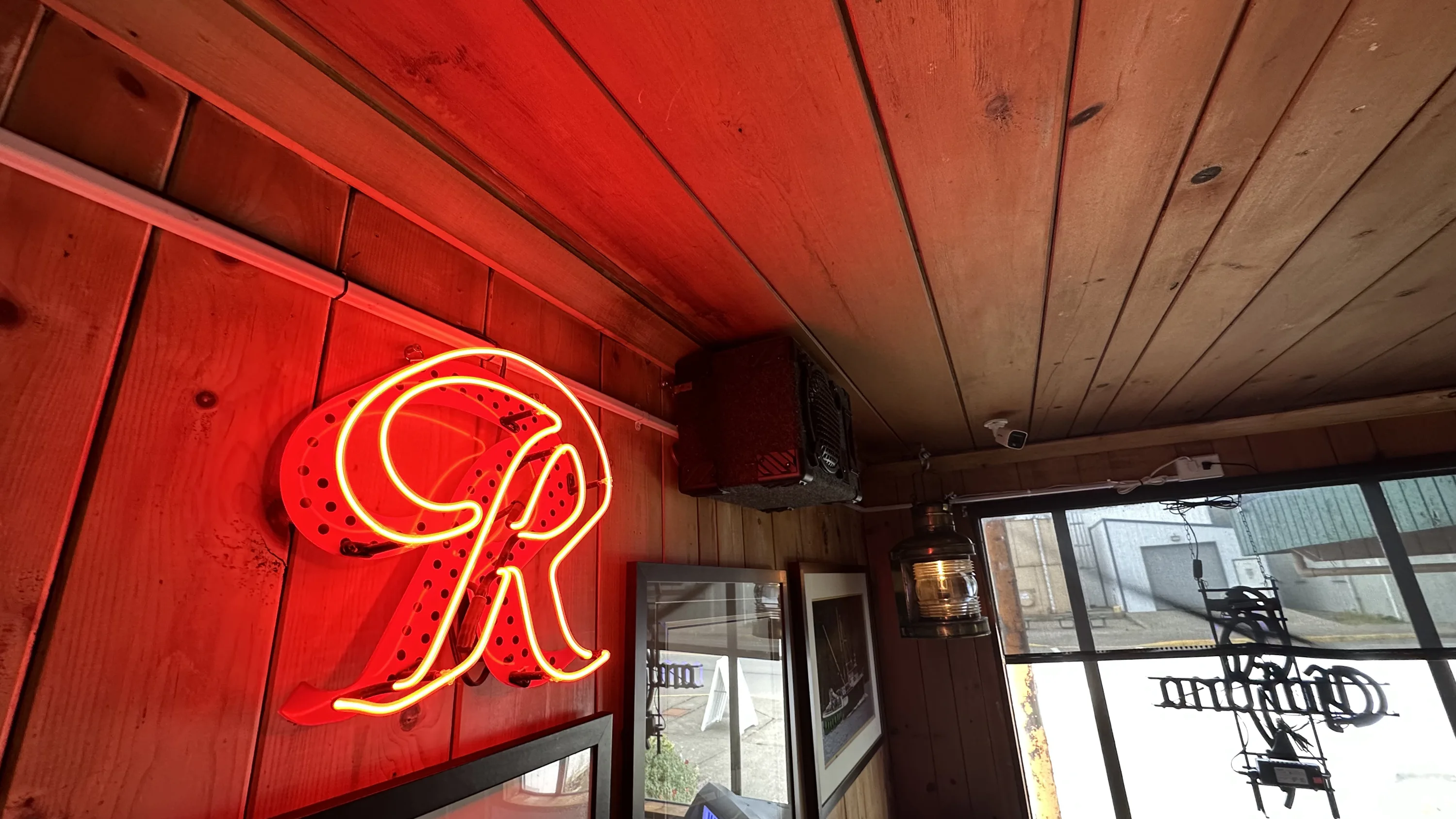 Wood-paneled room with a red neon 