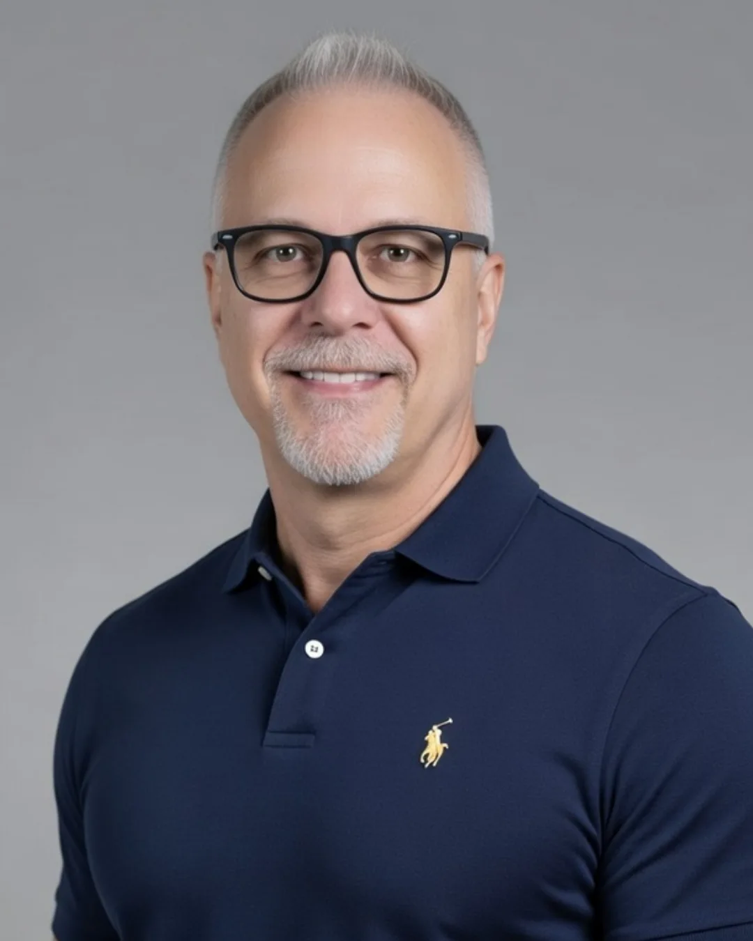 Vine Maple Place CEO William Splitberger Headshot - smiling man with glasses and a gray goatee wearing a navy polo