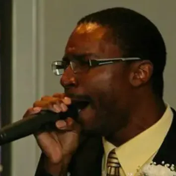 A man in a suit singing into a microphone